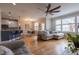 Open-concept living space with hardwood floors, ceiling fan, and view into the kitchen at 441 Heritage Village Ln, Apex, NC 27502