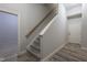 Carpeted staircase with wooden handrail and white trim leads to a finished basement at 441 Heritage Village Ln, Apex, NC 27502