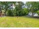 Large backyard with mature trees and firepit at 4906 Lakemont Dr, Raleigh, NC 27609
