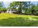 Beautifully maintained backyard with lush green lawn and mature trees at 4906 Lakemont Dr, Raleigh, NC 27609