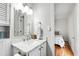 Stylish bathroom with marble countertop, decorative mirror, and updated fixtures at 4906 Lakemont Dr, Raleigh, NC 27609