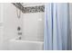 Bathroom featuring a tub with white subway tile surround and a decorative mosaic accent stripe at 4906 Lakemont Dr, Raleigh, NC 27609