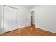 Bedroom features hardwood floors, a large closet, and white walls, creating a bright and inviting space at 4906 Lakemont Dr, Raleigh, NC 27609