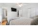 Light-filled bedroom with hardwood floors, ceiling fan, and access to the bathroom and hallway at 4906 Lakemont Dr, Raleigh, NC 27609