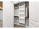 Closet with built-in shelving and hanging rods, perfect for convenient and organized storage at 4906 Lakemont Dr, Raleigh, NC 27609