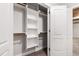 Open closet with built-in shelving and hanging rods, perfect for efficient and stylish organization at 4906 Lakemont Dr, Raleigh, NC 27609
