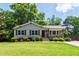 Charming single-story home with a well-maintained lawn, stone accents, and inviting curb appeal at 4906 Lakemont Dr, Raleigh, NC 27609