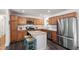 Spacious kitchen featuring stainless steel appliances, custom cabinetry, granite counters and breakfast bar seating at the island at 4906 Lakemont Dr, Raleigh, NC 27609