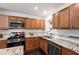 Kitchen showcasing custom cabinets, granite counters, a decorative window, stainless appliances, and white subway tile backsplash at 4906 Lakemont Dr, Raleigh, NC 27609