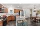 Well-lit kitchen with granite countertops, stainless appliances, an island with bar seating and an adjacent dining area at 4906 Lakemont Dr, Raleigh, NC 27609