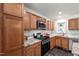 Bright kitchen featuring stainless steel appliances, wood cabinets, granite counters and a unique stain glass window at 4906 Lakemont Dr, Raleigh, NC 27609