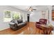 Bright living room with hardwood floors, a large window, and comfortable seating at 4906 Lakemont Dr, Raleigh, NC 27609