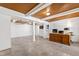 Spacious office with wooden ceiling beams, tan tiled floors, and white walls, perfect for working from home at 4906 Lakemont Dr, Raleigh, NC 27609