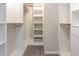 A walk-in closet with white shelving and drawers at 503 Kinship Ln, Apex, NC 27502