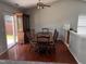 A dining room with hardwood floors, a wooden table with chairs, and a china cabinet at 503 Kinship Ln, Apex, NC 27502