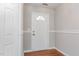 Clean entryway with a white front door and hardwood floors, creating a welcoming first impression at 503 Kinship Ln, Apex, NC 27502