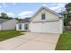 View of a cozy home featuring a two-car garage and blue shutters at 503 Kinship Ln, Apex, NC 27502