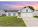 Charming single-Gathering home featuring a two-car garage and well-maintained front lawn at sunset at 503 Kinship Ln, Apex, NC 27502