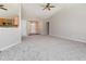 Open-concept living room with vaulted ceiling, plush carpeting, and access to other rooms at 503 Kinship Ln, Apex, NC 27502
