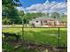 Spacious backyard featuring a bench, chain-link fence, and mature trees at 508 E Mcneill St, Lillington, NC 27546