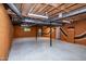 Finished basement with painted walls and exposed beams, enhanced by natural light at 5213 Tomahawk Trl, Raleigh, NC 27610