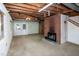 Basement featuring a brick fireplace and walkout to yard at 5213 Tomahawk Trl, Raleigh, NC 27610