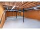 Unfinished basement with exposed wood beams, painted walls, and support poles at 5213 Tomahawk Trl, Raleigh, NC 27610
