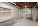 Basement area featuring an utility sink, toilet, and storage shelves at 5213 Tomahawk Trl, Raleigh, NC 27610