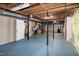 Unfinished basement with exposed beams, painted floor, and utility connections at 5213 Tomahawk Trl, Raleigh, NC 27610