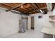 Basement featuring a water heater, utility table, and access to other rooms at 5213 Tomahawk Trl, Raleigh, NC 27610