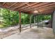 Covered basement area with a spiral staircase leading to the backyard at 5213 Tomahawk Trl, Raleigh, NC 27610