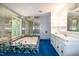 This bathroom features a large window, soaking tub, double vanity, and plenty of natural light at 5213 Tomahawk Trl, Raleigh, NC 27610