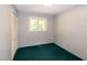 Bright bedroom featuring a window, closet with folding doors, and neutral wall color at 5213 Tomahawk Trl, Raleigh, NC 27610
