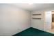 Bright bedroom featuring wood shelves and neutral wall color at 5213 Tomahawk Trl, Raleigh, NC 27610
