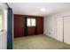 A cozy bedroom features a window with curtains, and a closet with folding doors at 5213 Tomahawk Trl, Raleigh, NC 27610