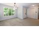 Dining room featuring a large window, modern lighting, and closet at 5213 Tomahawk Trl, Raleigh, NC 27610