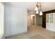 Open dining room featuring modern lighting, neutral walls, and access to other rooms in the home at 5213 Tomahawk Trl, Raleigh, NC 27610