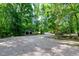 Gravel driveway leads to a home surrounded by trees at 5213 Tomahawk Trl, Raleigh, NC 27610