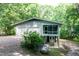 View of home with a two-car garage and an elevated screened-in porch at 5213 Tomahawk Trl, Raleigh, NC 27610