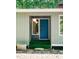 Close-up of blue front door with unique light fixtures and steps at 5213 Tomahawk Trl, Raleigh, NC 27610