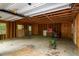 Unfinished two-car garage with exposed rafters providing ample space for storage or parking at 5213 Tomahawk Trl, Raleigh, NC 27610