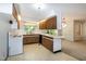Bright kitchen with wood cabinets, laminate countertops, and a view into the dining area at 5213 Tomahawk Trl, Raleigh, NC 27610