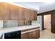 Kitchen area featuring wood cabinets, white countertops, and views into adjacent rooms at 5213 Tomahawk Trl, Raleigh, NC 27610
