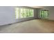 Bright living room with large windows providing outdoor views and natural light at 5213 Tomahawk Trl, Raleigh, NC 27610
