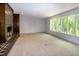 Bright living room with a brick fireplace and large windows offering natural light and outdoor views at 5213 Tomahawk Trl, Raleigh, NC 27610