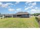 Expansive backyard with green grass with the home's screened porch and exterior at 565 Joseph Alexander Dr, Fuquay Varina, NC 27526