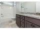 Bathroom with double sink vanity, granite countertop, and tub with shower at 565 Joseph Alexander Dr, Fuquay Varina, NC 27526