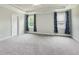 Spacious bedroom with a tray ceiling, carpet, and two windows for natural light at 565 Joseph Alexander Dr, Fuquay Varina, NC 27526