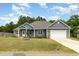Charming home with blue siding, stone accents, a well-manicured lawn, and attached garage at 565 Joseph Alexander Dr, Fuquay Varina, NC 27526