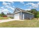 View of the detached garage with white door, blue siding and a concrete driveway at 565 Joseph Alexander Dr, Fuquay Varina, NC 27526